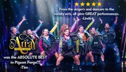 A group of lively performers are dancing on stage in colorful outfits with vibrant lighting effects in the background.