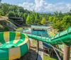 A group of people enjoy a ride on a yellow raft sliding down a water slide with an inset of a person having fun on a separate slide